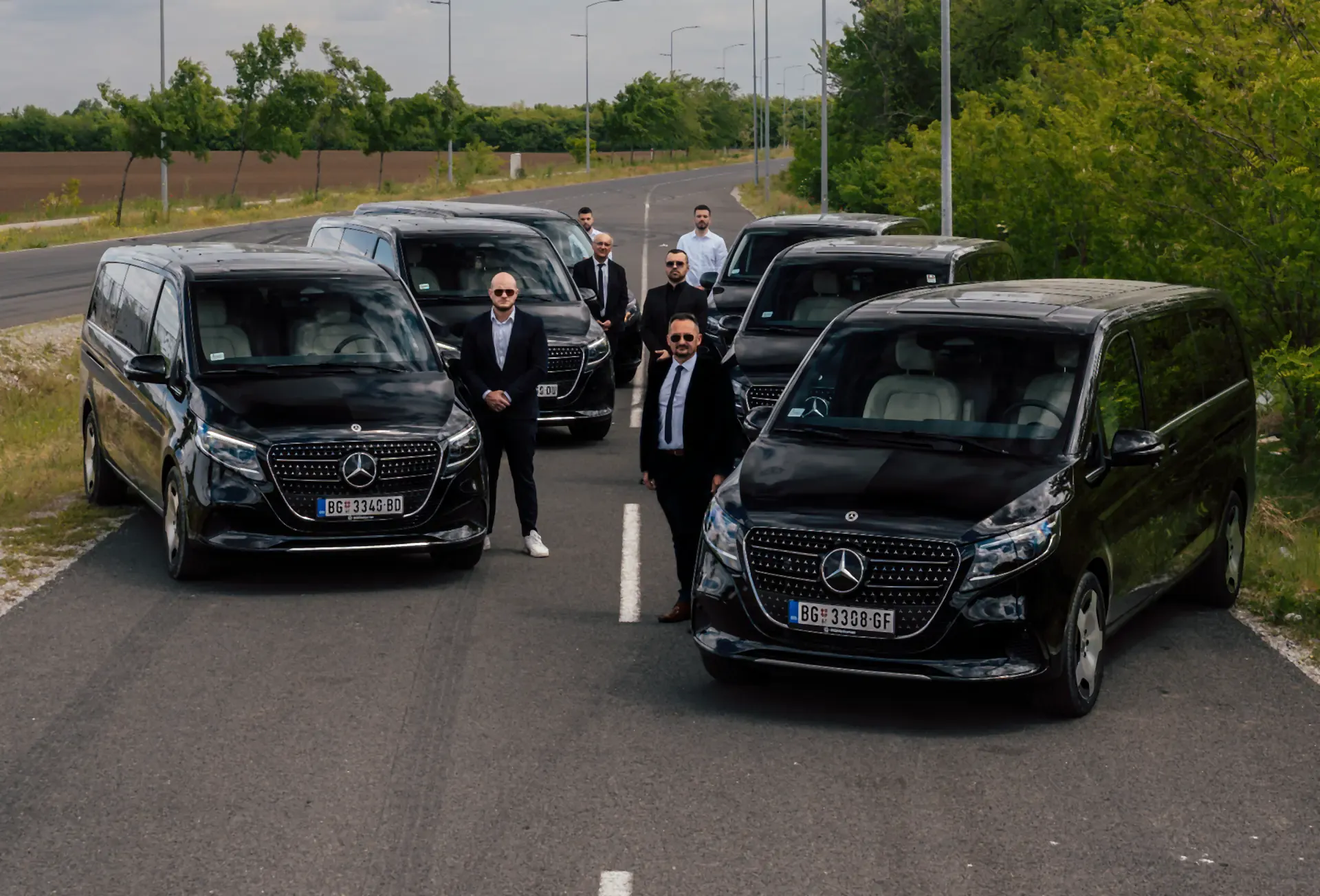 BG Diplomat chauffeurs beside their black Mercedes V-Class vans